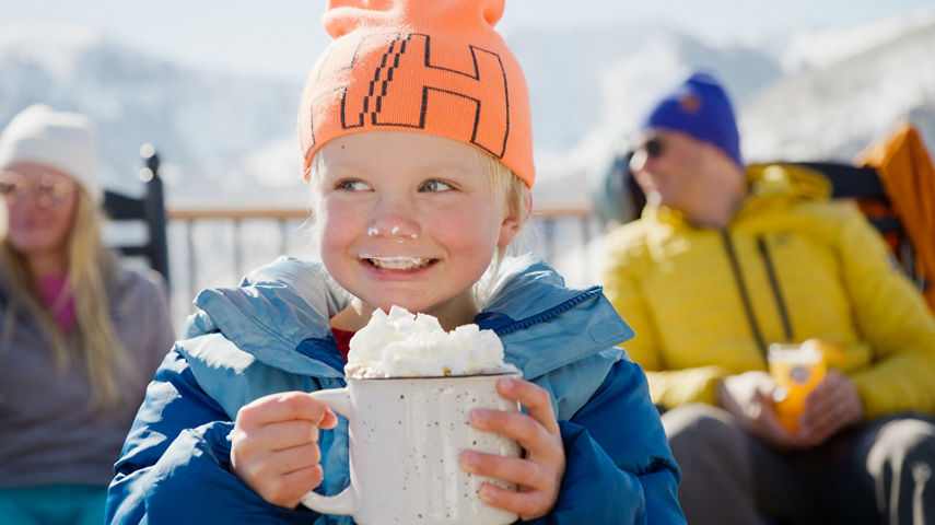 Young Child Enjoys Sipping on Hot Chocoloate