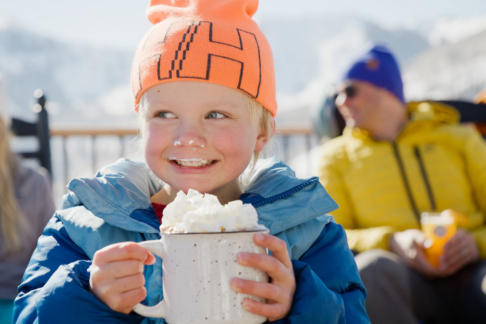 Young Child Enjoys Sipping on Hot Chocoloate