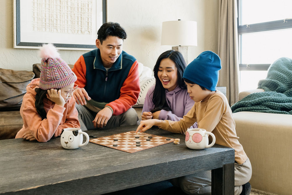 Family Enjoys Leisure Time Playing Boardgames in Their Unit at Grand Summit Lodging at Park City