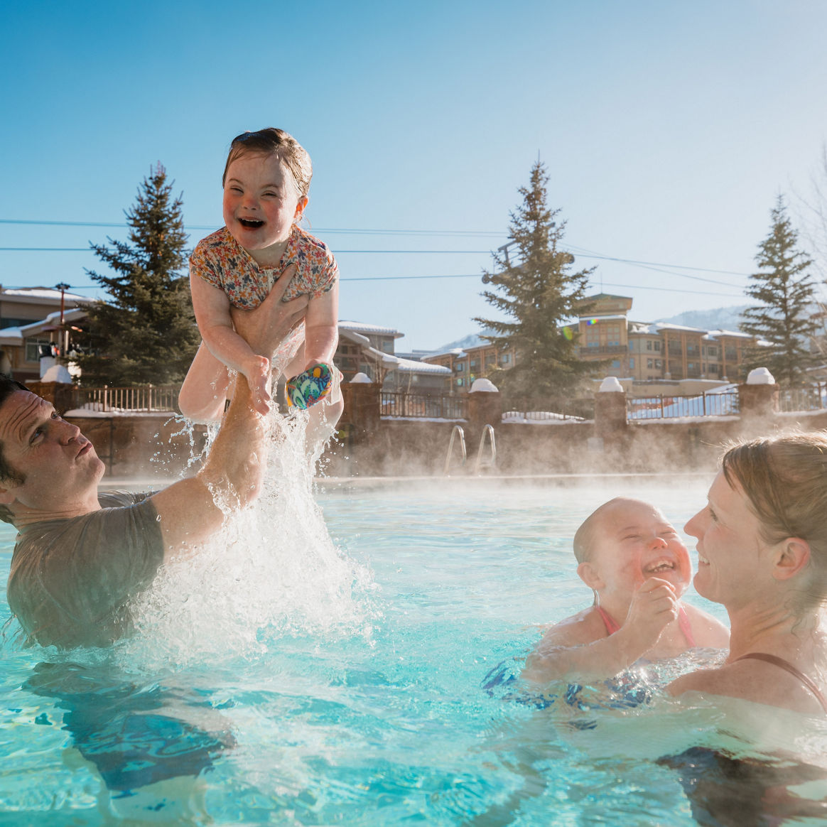 Family Enjoys a Winter Swim in a Heated Pool at Grand Summit at Park City