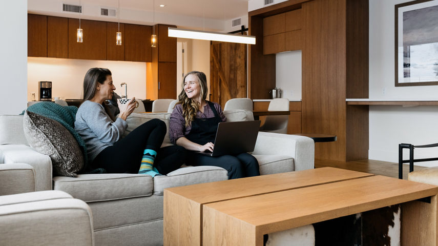 Couple Enjoys Sipping on Coffee in the Morning Inside Their Unit at Lift Lodging at Park City
