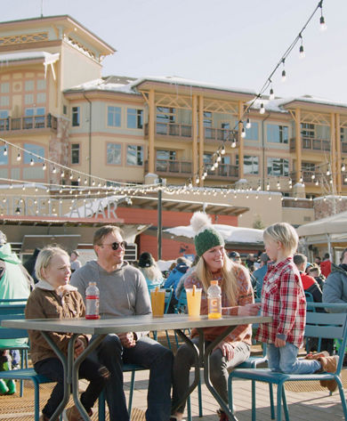 Family Enjoys Canyons Village Base Area Patio at Park City