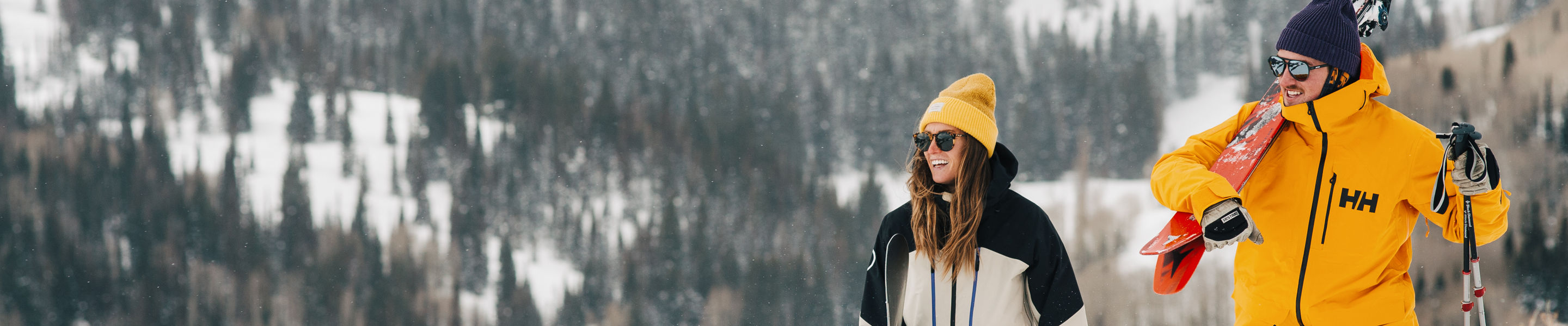 Skier and Snowboarder Enjoy Scenic Views While Hiking Up a Trail at Park City