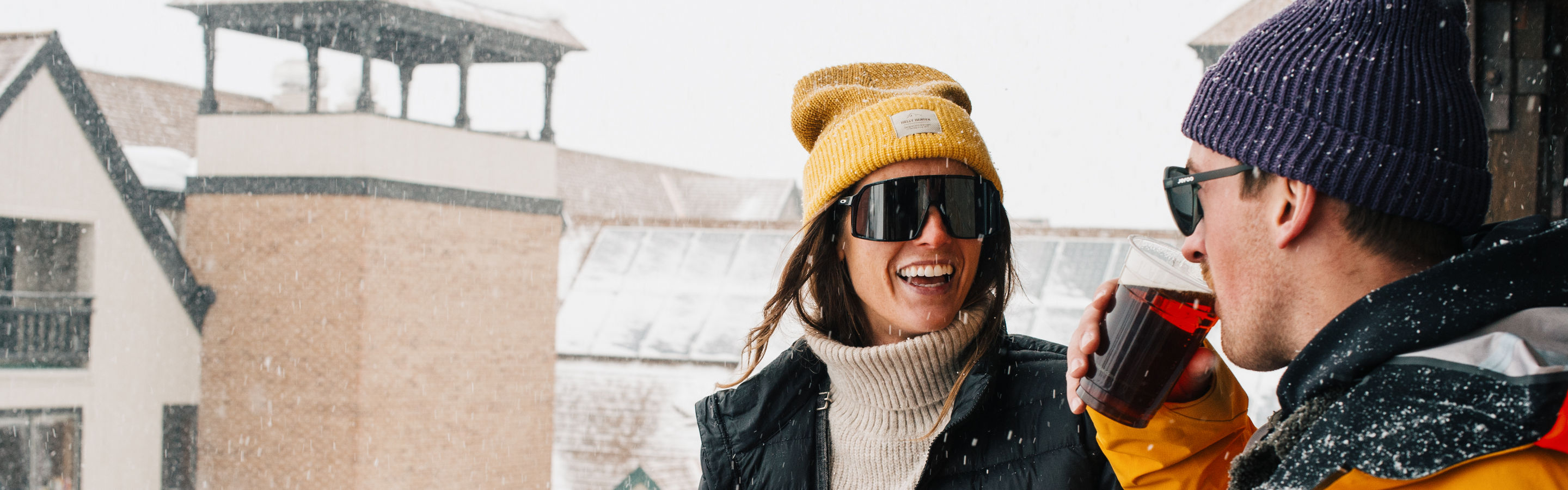 Woman and Man Enjoy Drinking a Beer During Apres at Park City