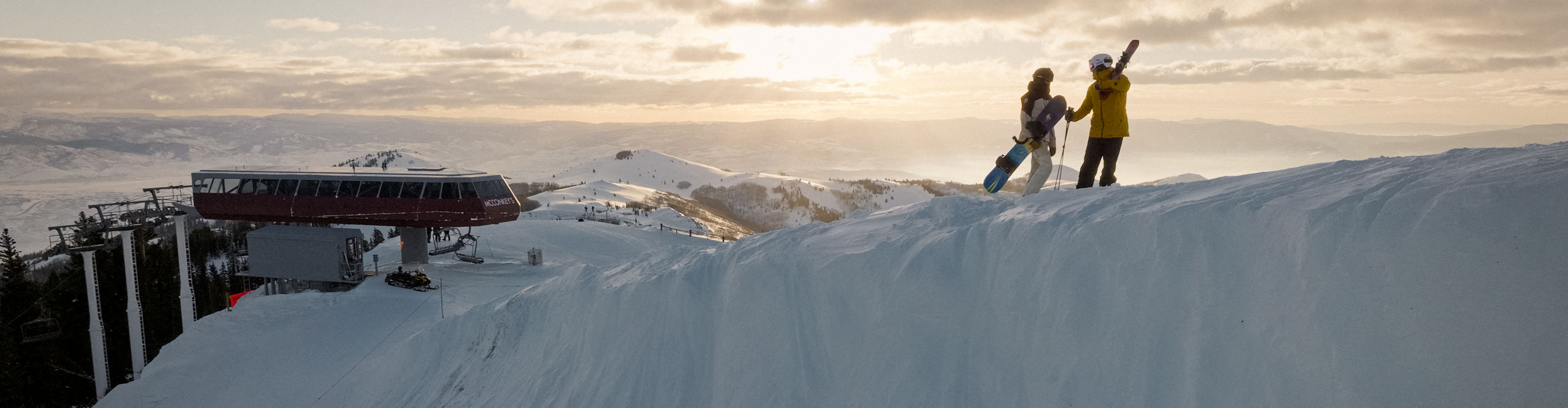 Skier and Snowboarder Enjoy Scenic Views While Hiking Up a Trail at Park City