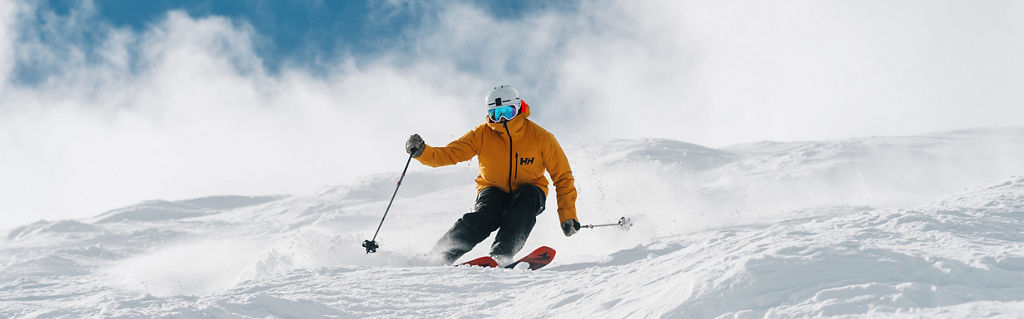 Skier in Yellow Jacket Skis Down Advanced Terrain at Park City