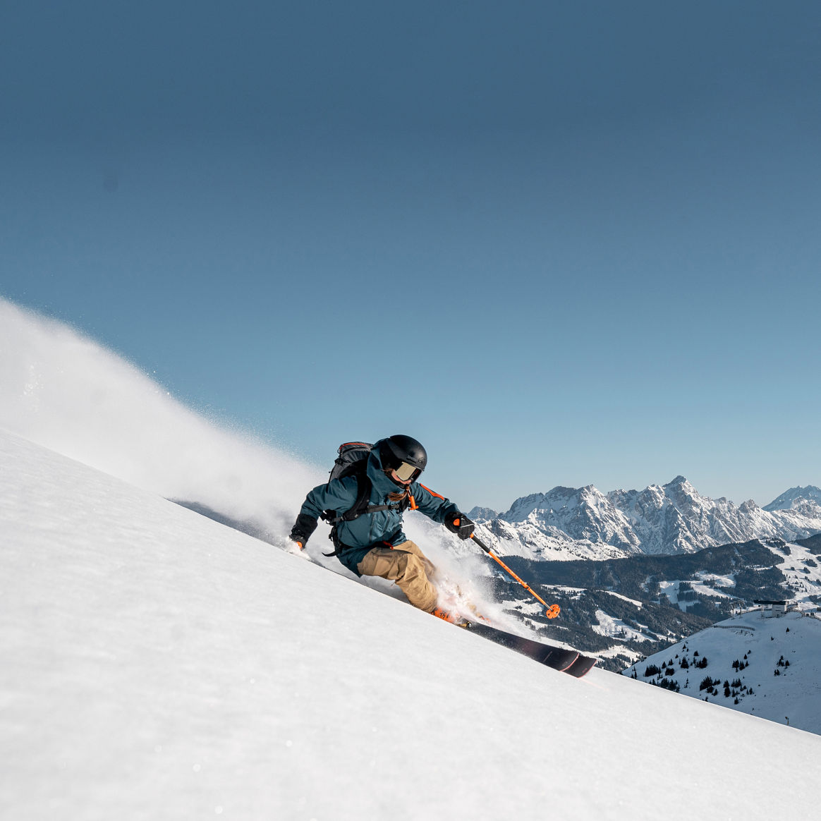 Skier Shredding Down Saalbach Trail During Bluebird Day