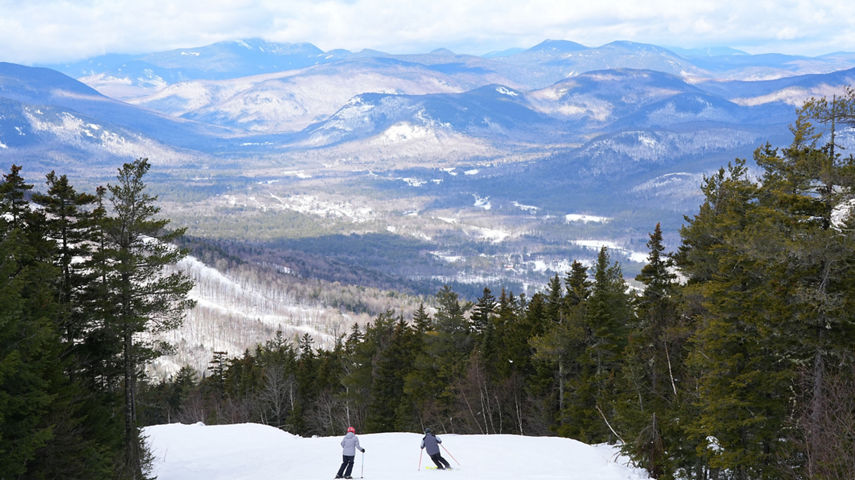 Two Skiers Descend Mountain at Attitash