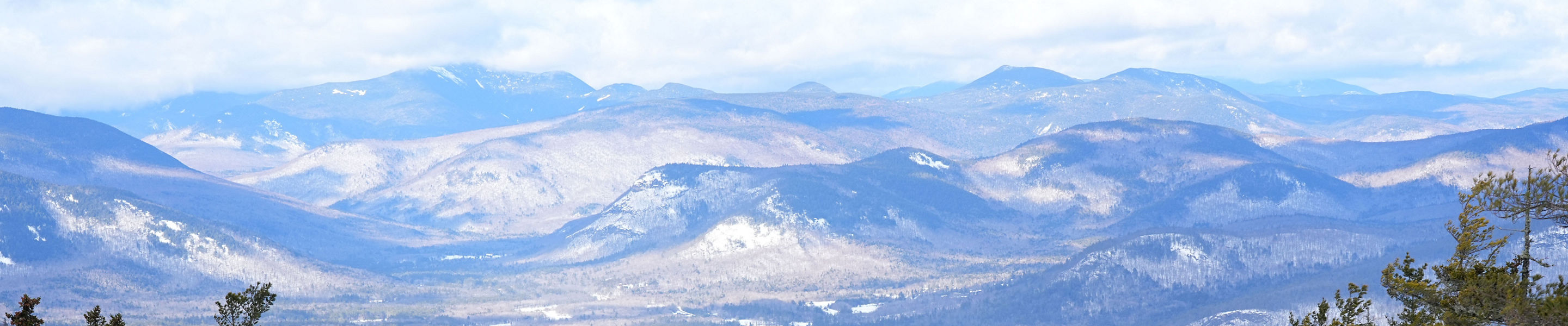 Two Skiers Descend Mountain at Attitash
