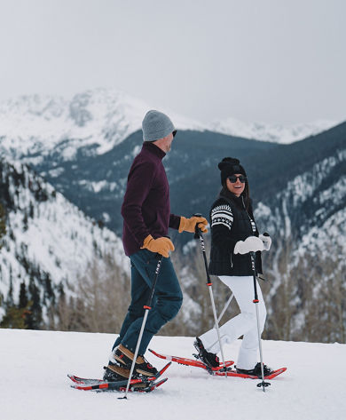 Couple Snowshoing with Scenic View in Background at Beaver Creek
