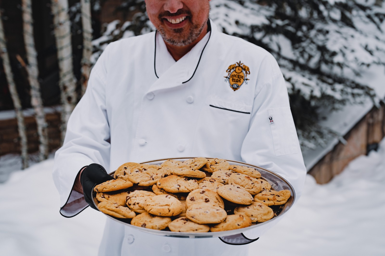 A Beaver Creek chef offering a tray of chocolate chip cookies during Cookie Time