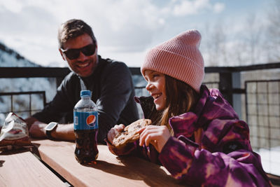 Father and Daughter Enjoying a Quick Snack in Between Runs at Beaver Creek