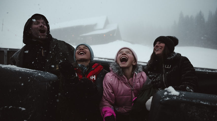 Family Catching Snowflakes Outside Beano's Cabin at Beaver Creek