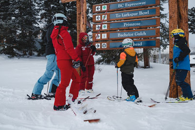 Family Stops to Chat with Employee Next to Wayside Signage at Beaver Creek