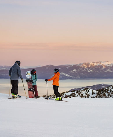 Resort Guests Stand at the Top of a Run as the Sun Rises at Heavenly
