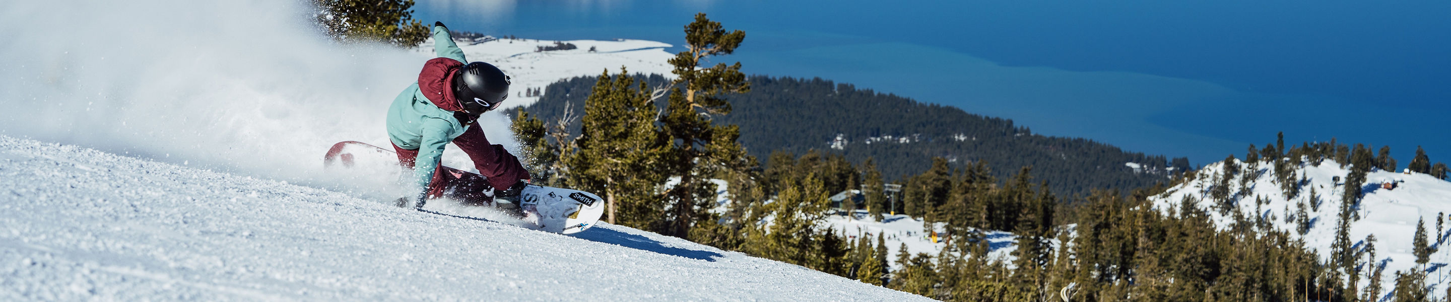 Snowboarder Hits a Run at Heavenly with a Scenic View of Lake Tahoe in the Background