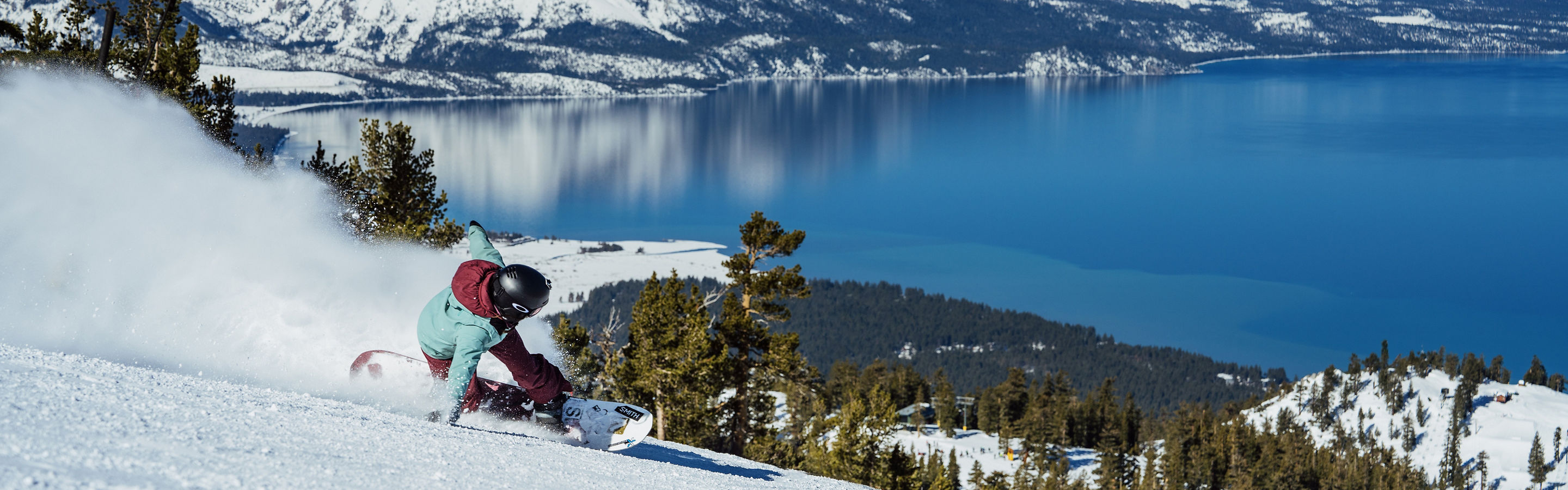 Snowboarder Hits a Run at Heavenly with a Scenic View of Lake Tahoe in the Background
