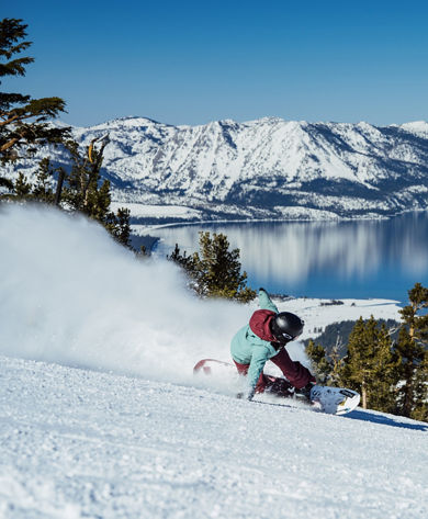 Snowboarder Hits a Run at Heavenly with a Scenic View of Lake Tahoe in the Background