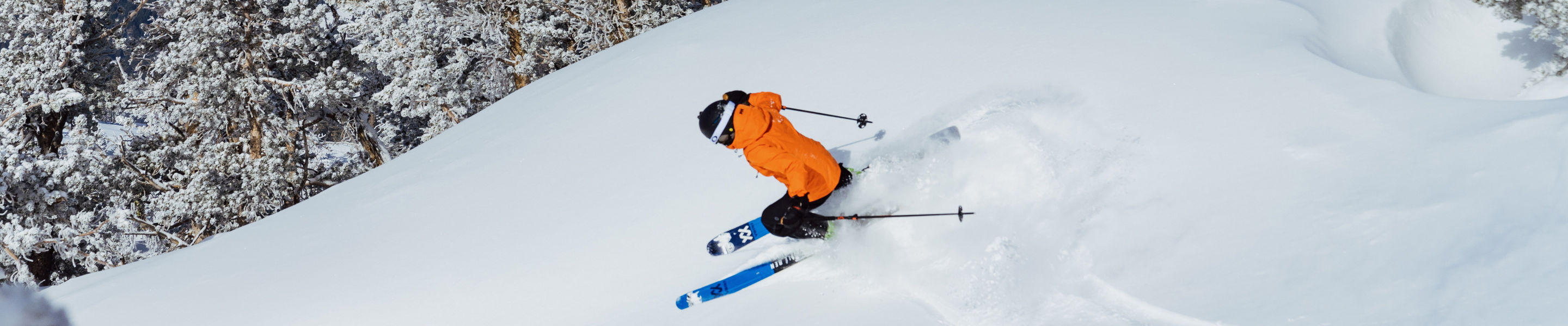Skier Shreds Through Fresh Powder on a Bluebird Day at Heavenly with Lake Tahoe in the Background