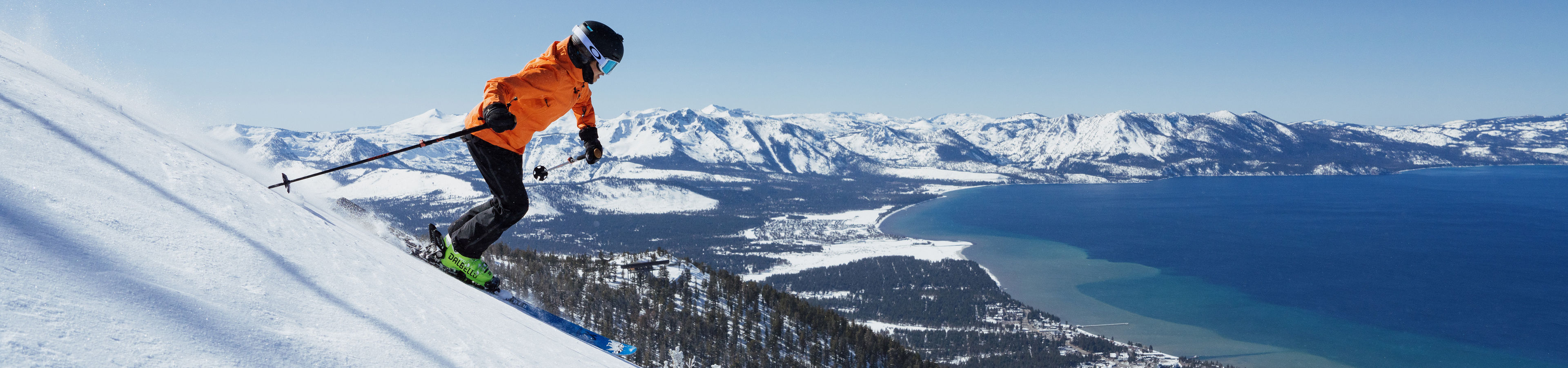 Skier Shreds Through Fresh Powder on a Bluebird Day at Heavenly with Lake Tahoe in the Background