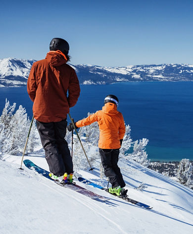 Skiers Take in Scenic Views at the Top of a Trail at Heavenly with Lake Tahoe in the Background