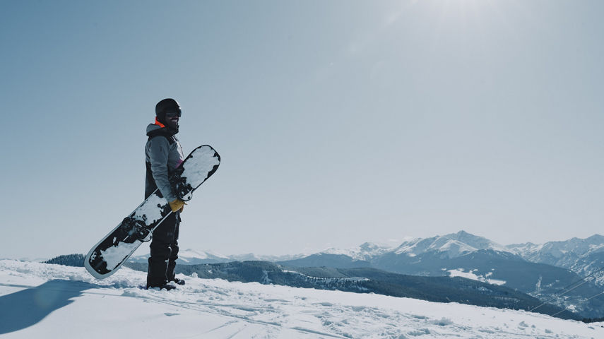 Snowboarder Admiring Scenic Landscape at Vail