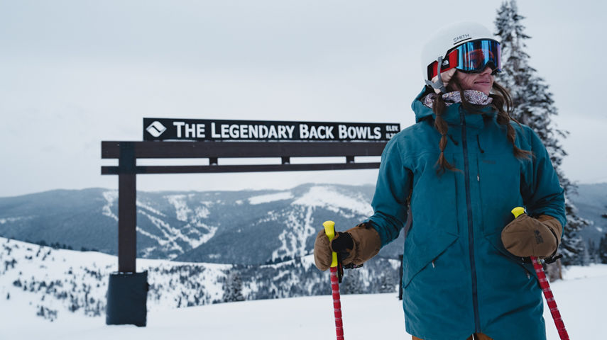 Skier Stands in Front of The Legendary Back Bowls Arch at Vail