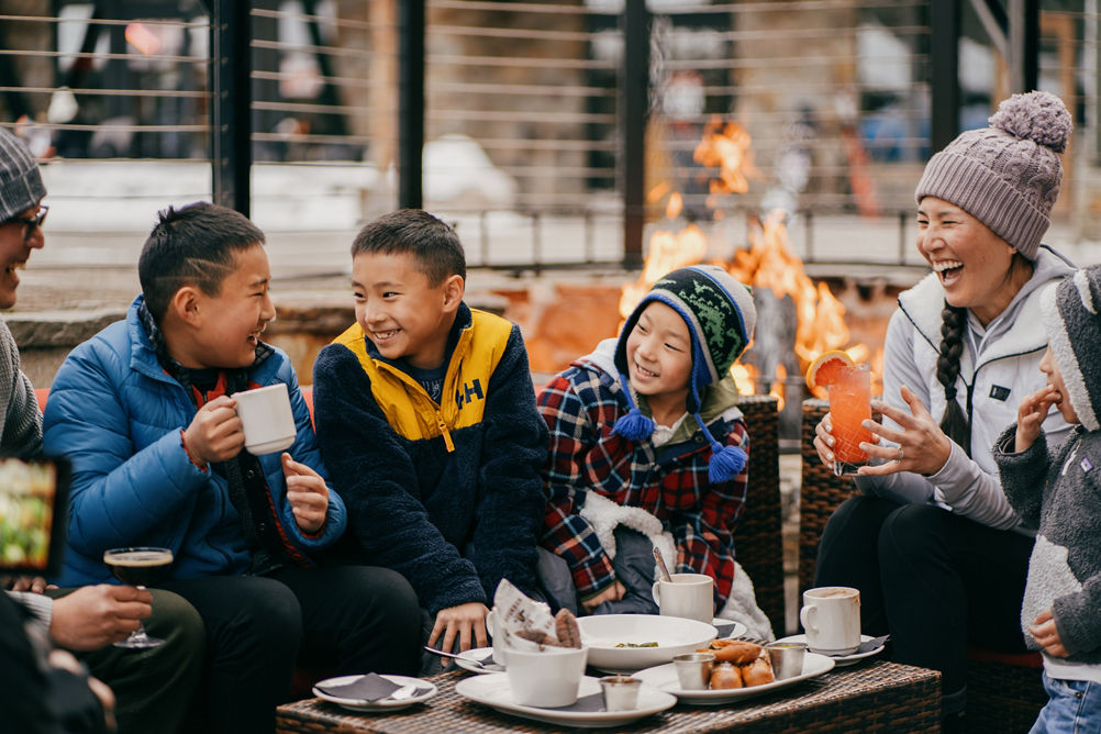 Family Enjoys Hot Cocoa and Snacks Near a Firepit at Northstar