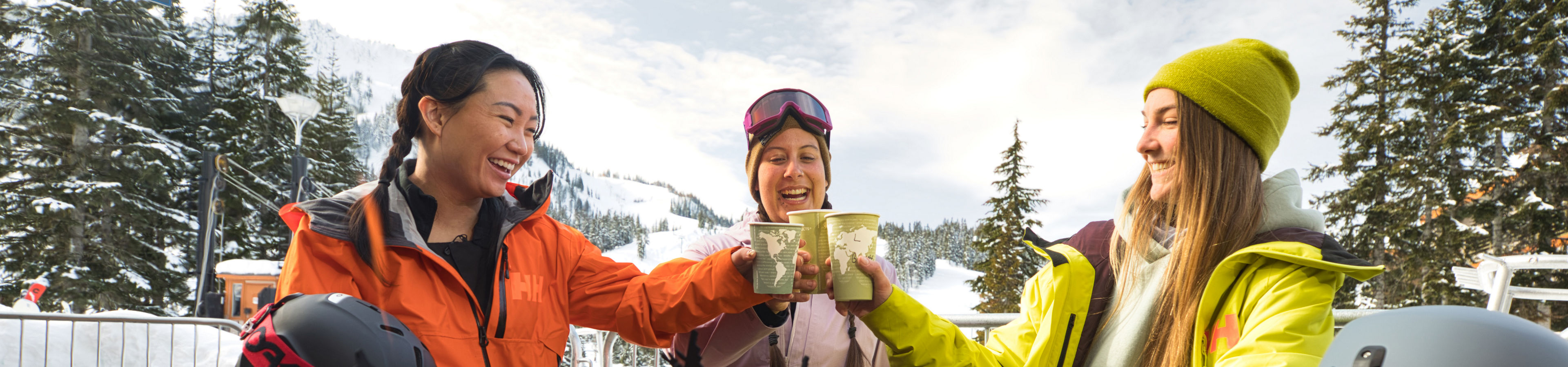 Resort Guests Drink Coffee Around a Firepit at Stevens Pass Base Area