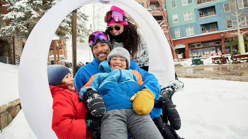 Family Sits in Circle Swing at Keystone