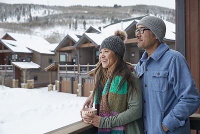 Couple Enjoys Scenic Views from Their Balcony at River Run Townhomes at Keystone