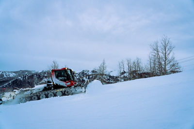 Snowcat pushing snow up a slope at Park City