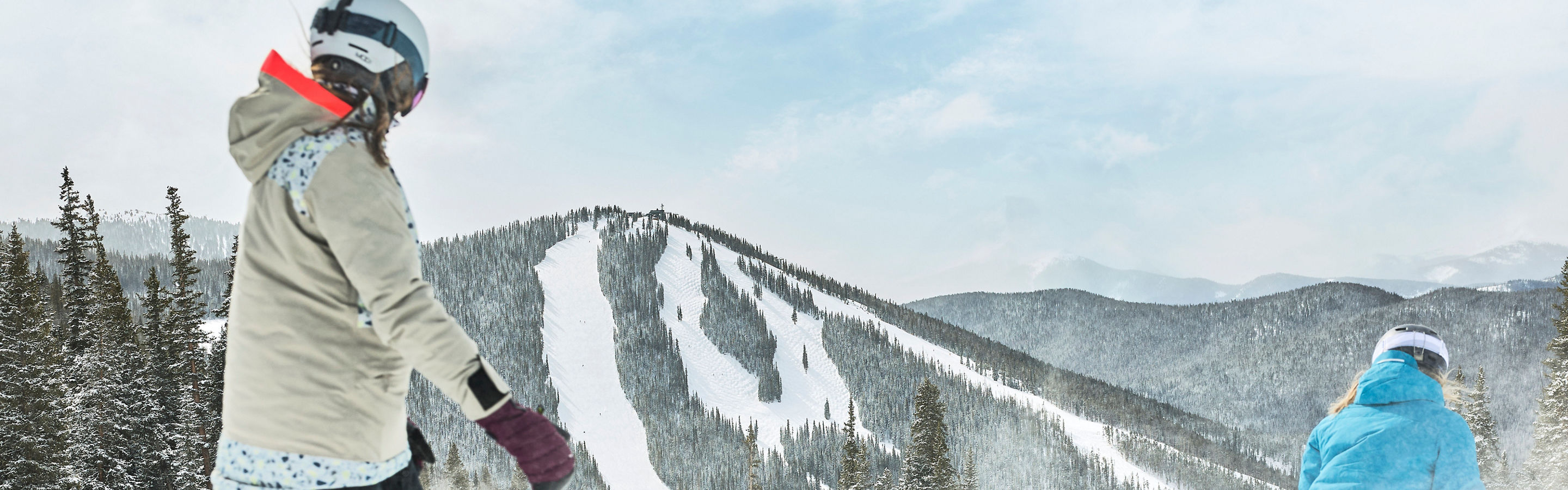 Group of Snowboarders and a Skier Enjoying Riding Down Fresh Snow on a Trail at Keystone