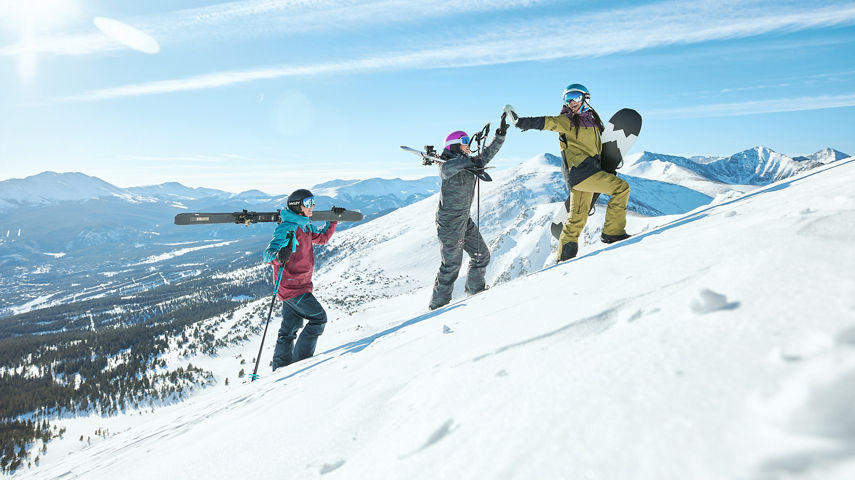 Skiers and Snowboarder Hiking Up Ski Trail with Gear at Breckenridge