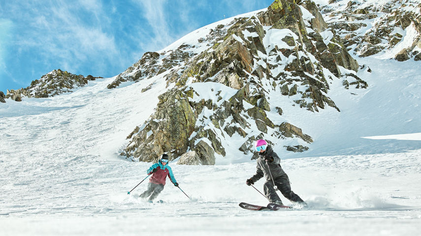 Friends Ride Down Advanced Terrain on a Bluebird Day at Breckenridge