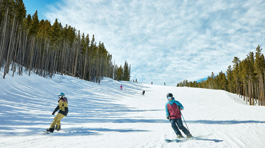 Skier and Snowboarder Hitting a Run at Breckenridge