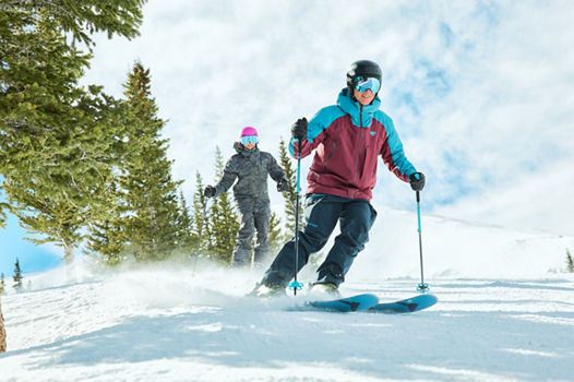 Skiers Hitting a Run Alongside Trees at Breckenridge