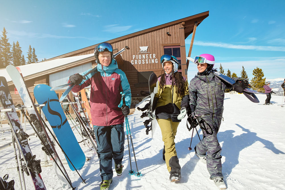 Friends Walking with Gear at Pioneer Crossing at Breckenridge