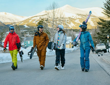 Group of Friends Walk Through the Town of Breckenridge with Gear