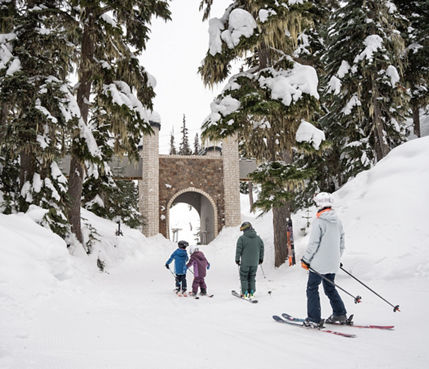 Family Skis Through Easy Trail Toward a Bridge Underpass at Whistler Blackcomb