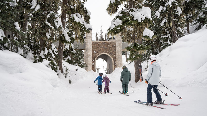 Family Skis Through Easy Trail Toward a Bridge Underpass at Whistler Blackcomb