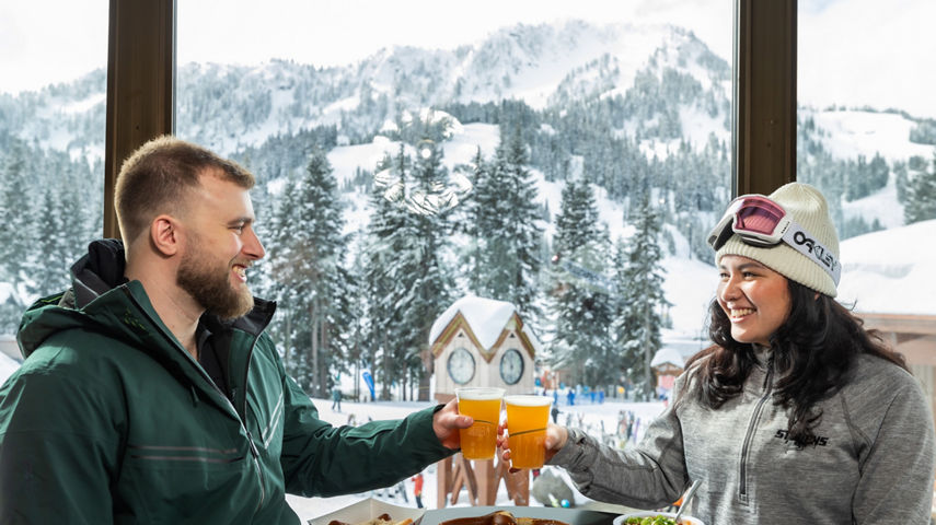 Couple Clink Beer Glasses at Biergarten at Stevens Pass