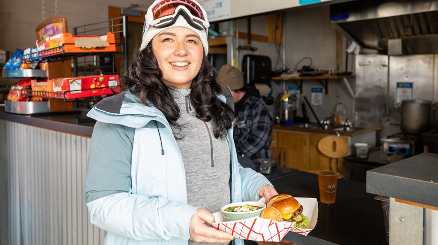 Resort Guest Picks Up Food from Counter at Outer Limits at Stevens Pass