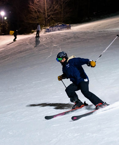 Skier Makes Turn at Dew After Dark Event at Crotched