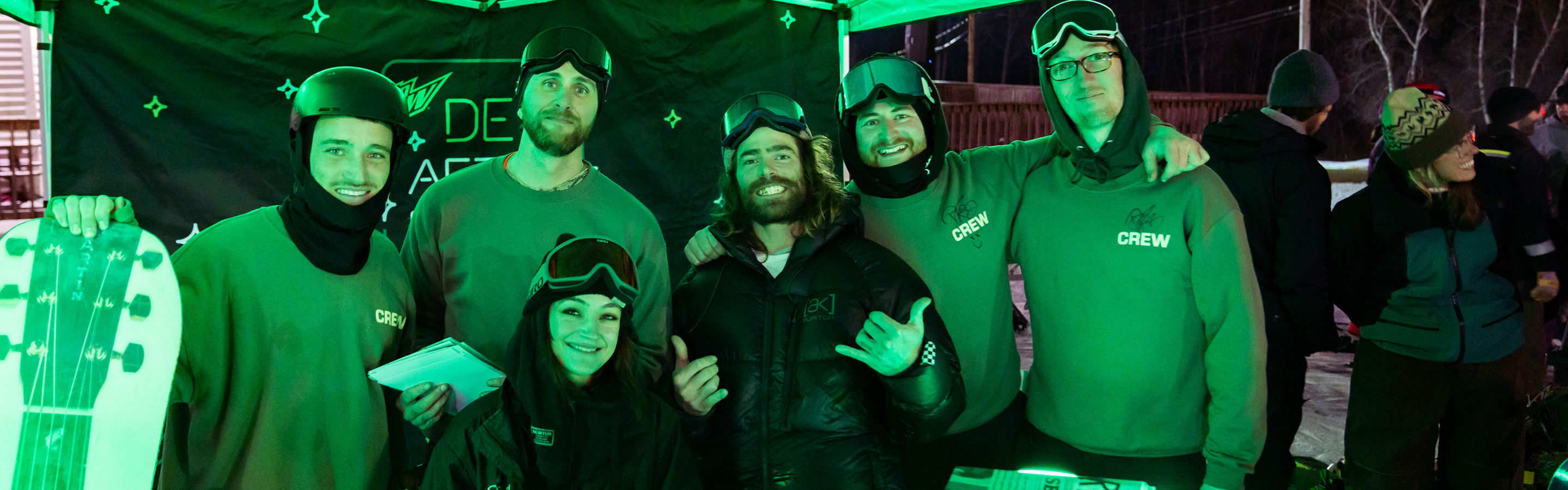 Crotched Guests Pose under Dew After Dark Tent at Event