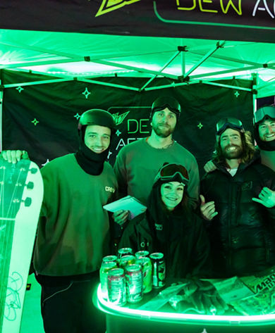 Crotched Guests Pose under Dew After Dark Tent at Event