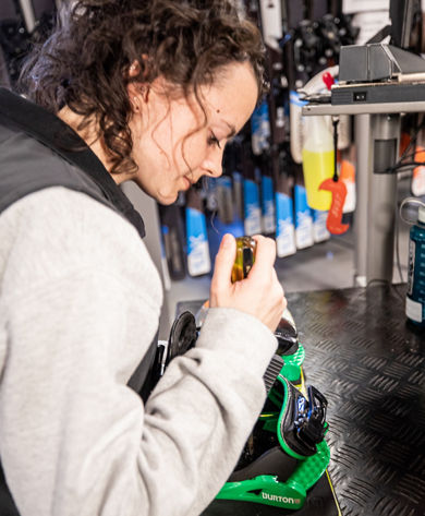 Rental Employee Adjusting Snowboard Boot at Stevens Pass