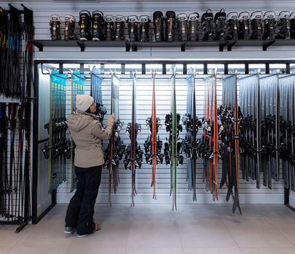 Resort Guest Browses Ski Equipment at Epic Mountain Rentals Location at Whistler Blackcomb