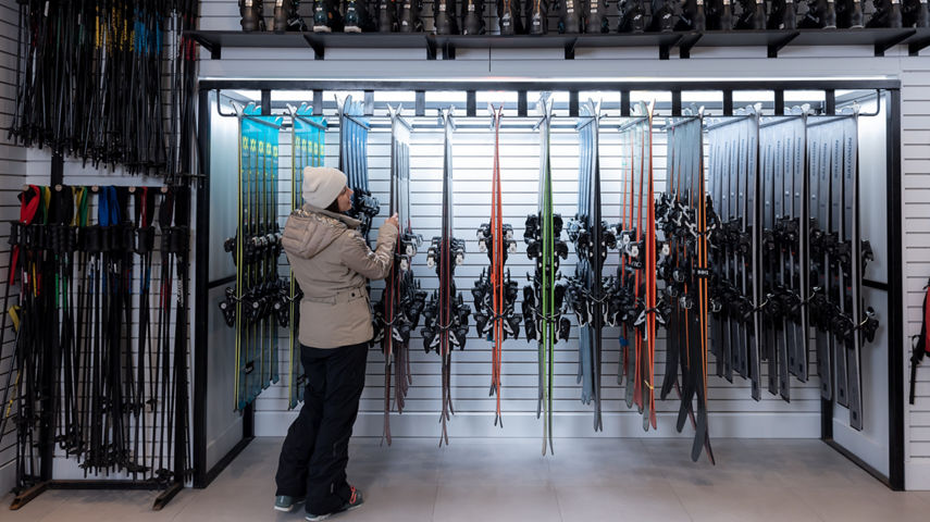 Resort Guest Browses Ski Equipment at Epic Mountain Rentals Location at Whistler Blackcomb