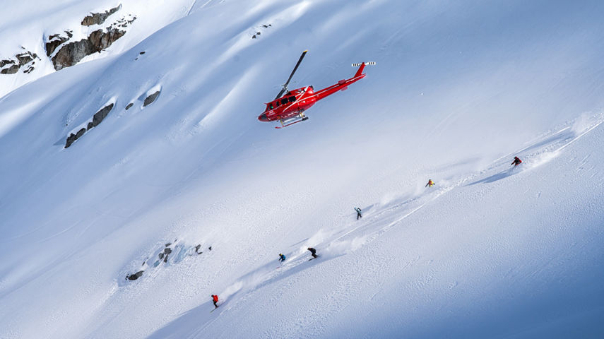 Skiers and Snowboarders Drop Into Deep Powder During a Helliskiing Adventure at Whistler Blackcomb